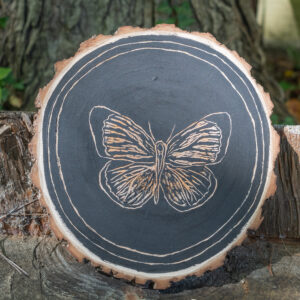 A butterfly carved into wood.