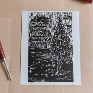Print of a tree near a river with Psalm 42:1 in the background.